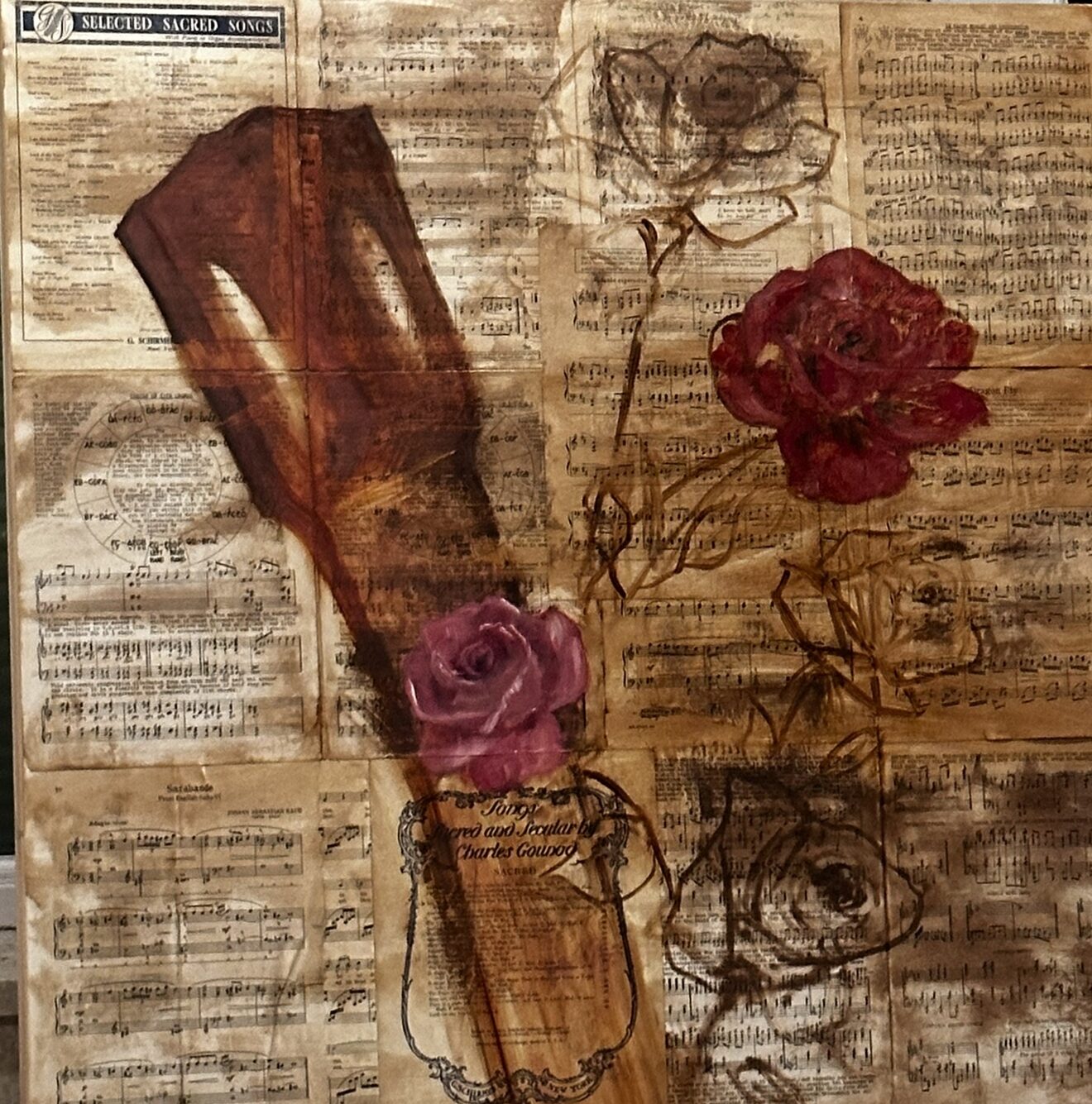 Old sheet music pages collaged and stained brown, with a guitar headstock, two painted roses in red and pink, and three roses still in brown outline.